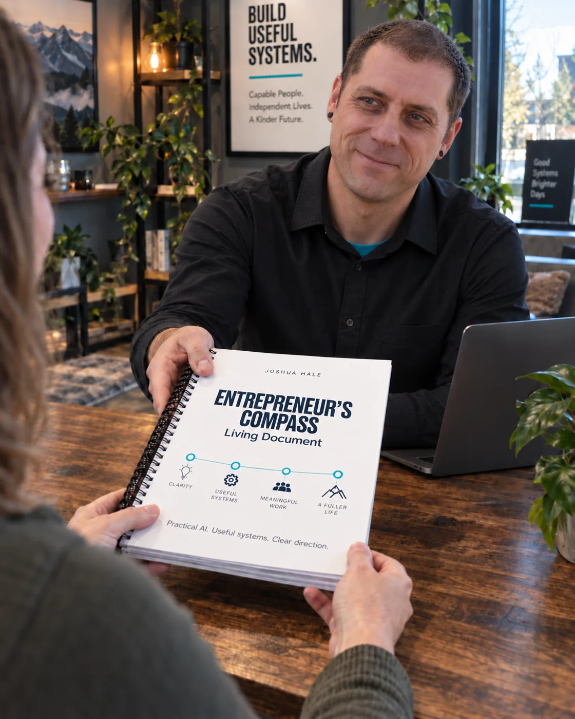 Joshua handing over an Entrepreneur’s Compass workbook